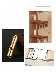 Detailed macro view of gold whistle pendant and silver buckle on beige leather bag