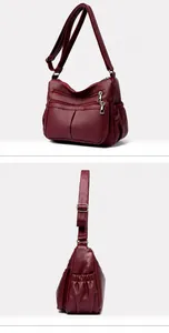 Macro della trama in pelle bordeaux e dettagli funzionali multi-zip su una borsa da donna