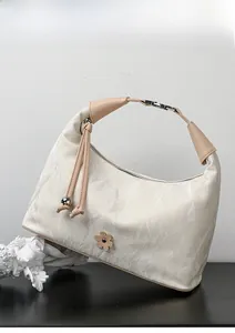 Detailed shot of a creamy white dumpling bag featuring marble texture and floral detail