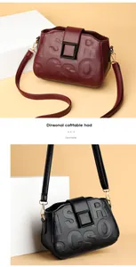 Detail view of lychee grain leather crossbody bag with embossed letters and matte buckle
