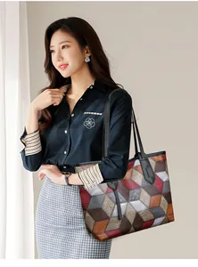 Modern tote bag with geometric patchwork and large capacity shown on a model by the window