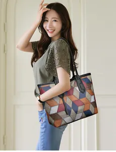 Detail shot of a large tote bag with multi-color geometric 3D puzzle pattern design