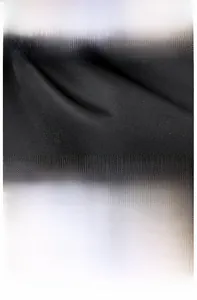 Close-up of black oxford fabric texture and brand logo tag on a large women backpack