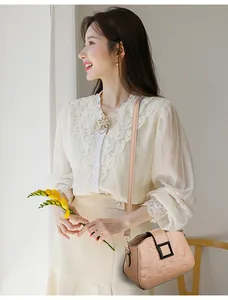 Detail of beige crossbody bag with embossed texture and black square buckle closure