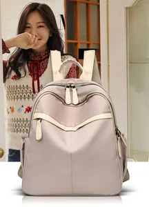 Detailed view of lavender nylon backpack with multi-pocket design and contrast trim