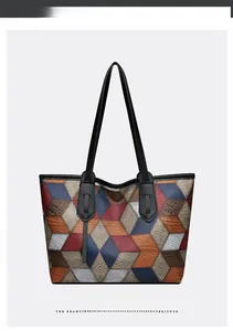Detailed view of large tote bag with colorful geometric patchwork and faux crocodile texture