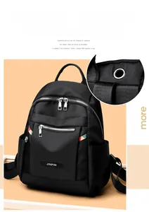 Detail of black oxford backpack showing built-in headphone port and stylish zipper pullers