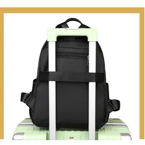 Detail of black oxford backpack showing the luggage strap for easy travel attachment