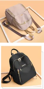 Detail of waterproof nylon backpacks with metal zippers in black and apricot colors