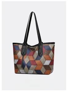 Macro detail of multi-color patchwork leather tote bag with embossed crocodile and lizard patterns