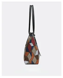 Side view of multi-color patchwork tote bag with embossed crocodile leather texture