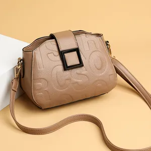 Brown lychee leather crossbody bag with embossed lettering and square metal buckle