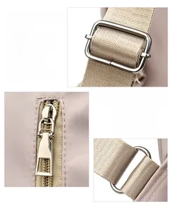Detailed macro view of polished silver-toned metal hardware on beige nylon backpack