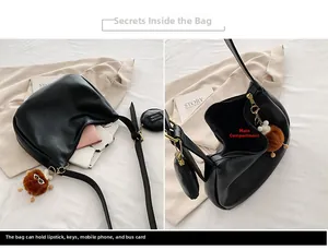 Detail view of black canvas hobo bag with spacious main compartment and round coin pouch