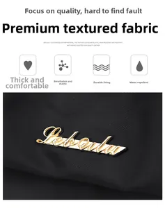 Close-up of black high-density waterproof fabric with gold metal logo and durable lining