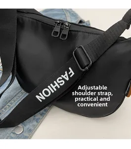Detail of adjustable nylon shoulder strap with FASHION text and dual zipper closure