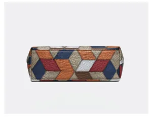 Detail view showing rectangular patchwork base of PU tote bag with pebbled texture