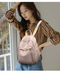 Detailed view of pink oxford backpack with high-density fabric and metal logo detail
