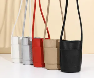 Detailed row of mini crossbody phone bags in five colors with lychee texture leather