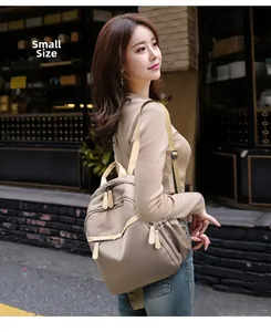 Detailed view of the small beige nylon backpack for women with a compact design