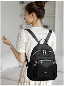 Close-up of black Oxford backpack with colorful zipper pullers and side water bottle pocket