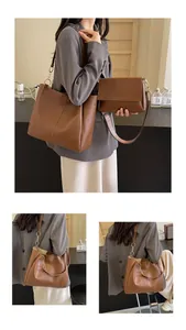 Detail view of dark brown leather tote and crossbody bag set with chain on model