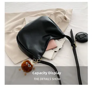Capacity display of black crescent hobo bag with mini coin purse and plush charm
