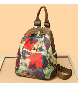 Detailed macro view of nylon backpack with floral prints and retro bronze metal lock