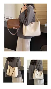 Close-up of a stylish brown crossbody bag and off-white tote with woven straps