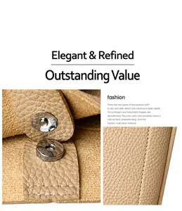Close-up of litchi grain leather bag showing metal magnetic buckle and white stitching
