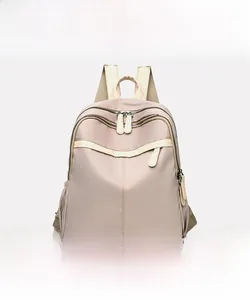 Front view of a khaki waterproof nylon backpack for women with beige trim and dual zippers