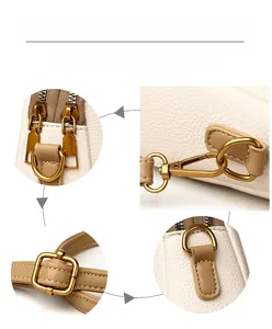 Détail du sac en cuir crème avec ferrures dorées, fermetures et bandoulière réglable