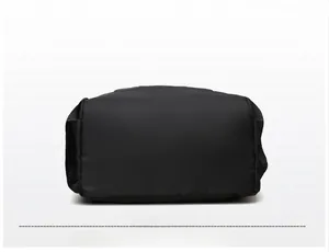 Detailed macro view of the wide black Oxford fabric backpack base with neat stitching
