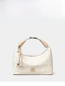 Detail view of cream dumpling bag featuring marble texture, floral accent and tassel charm