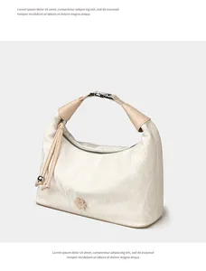 Detail of cream hobo bag featuring crinkled texture, metallic flower and drawstring