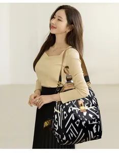 Detail of a large nylon backpack with black and white abstract patterns and a metal buckle