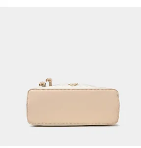 Detailed close-up of apricot dumpling bag base with premium lychee grain leather finish