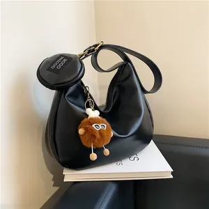 Minimalist black crescent hobo bag with round coin purse and cute plush charm pendant