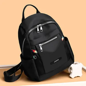 Women's black Oxford backpack with silver zippers and colorful geometric stripe details