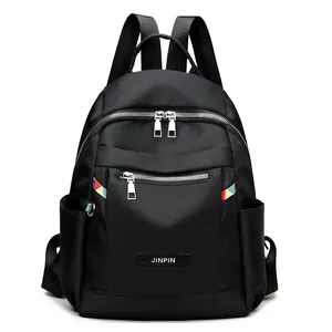 Waterproof black oxford backpack with multi-zipper pockets and colorful ribbon detail