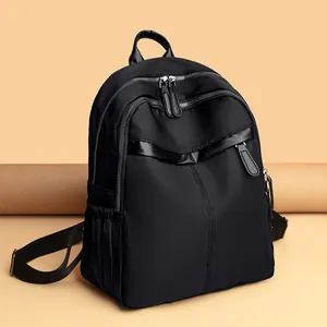 Women's black nylon backpack with multi-zipper compartments and adjustable straps