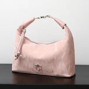 Pink marble texture dumpling handbag with floral charm and unique buckle handle