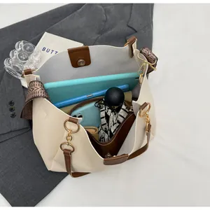 Internal view of off-white tote bag showing high capacity for tablets and daily items