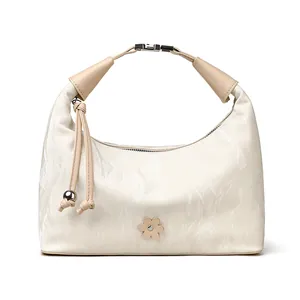 Beige pleated handbag with metallic clasp handle and leather flower detail for women