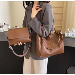Detail of brown leather tote and crossbody bag with stylish geometric woven strap