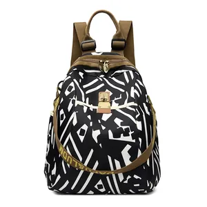 Women's black and white geometric nylon backpack with durable brown fabric straps
