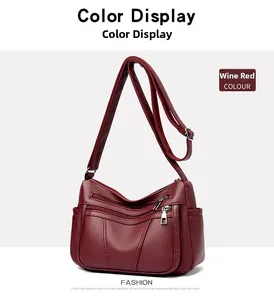 Detail shot of wine red litchi texture faux leather crossbody bag with silver zippers
