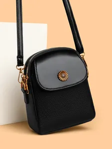 Petit sac bandoulière noir en cuir grainé avec fermoir tournesol doré élégant