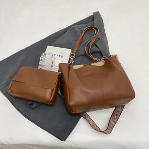 Brown leather tote bag and crossbody bag set with patterned strap for professional women