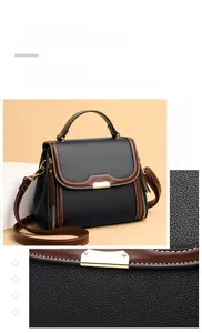 Close-up of litchi grain leather texture and contrast stitching on crossbody bag